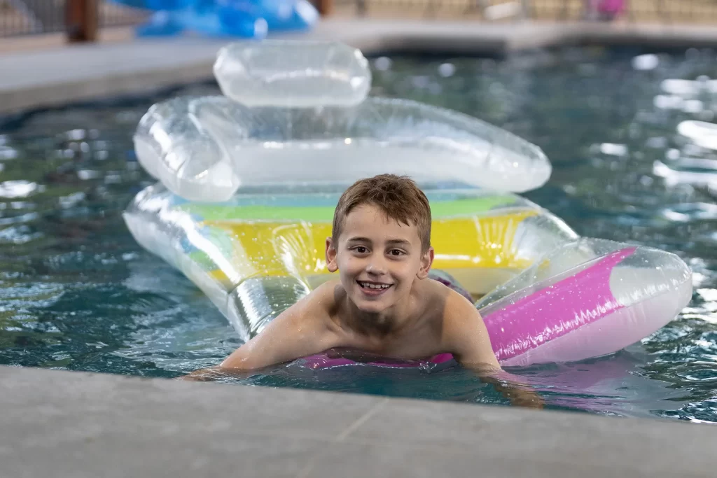 smile boy in the adina pool